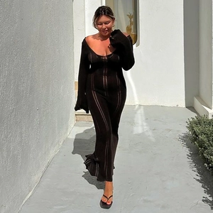 Close-up of a black long-sleeve knit maxi dress featuring a low U-neck and striped texture