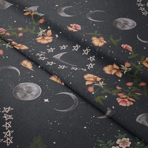 Close-up of moon and stars pattern on soft grey fabric texture of moon phase tapestry