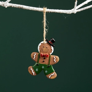 Brown resin gingerbread man Christmas ornament with red bowtie and green suspenders
