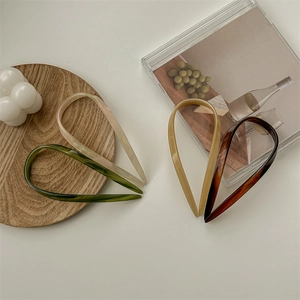 U-shaped acetate hair pins in marble and amber textures for elegant hairstyling