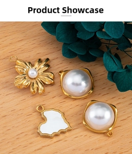 DIY gold floral pearl pendants and white enamel heart charms on a wooden table