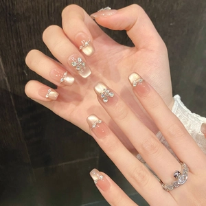 Elegant cat-eye press-on nails with golden gradient and sparkling zircon butterfly charms