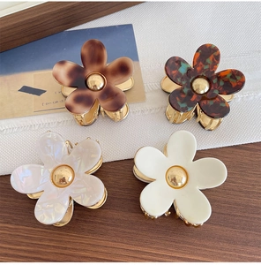 Detailed set of four elegant acetate flower hair claws with durable metal base and grips