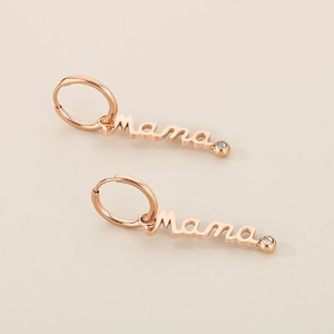 Close-up of rose gold Mama letter earrings with sparkling crystal accents and hoop