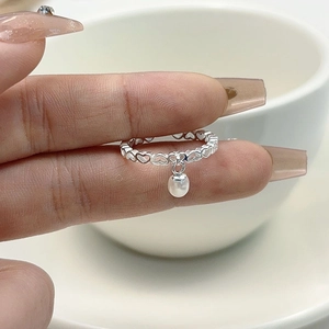 S925 sterling silver hollow heart ring featuring a dangling white freshwater pearl charm