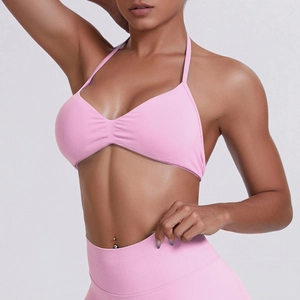 Detail of pink halter neck sports bra with ruched V-neck and high elasticity fabric
