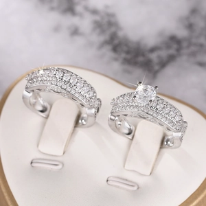 Close-up of a two-piece wedding ring set with cubic zirconia in a heart-shaped box