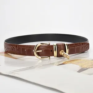 Women's brown crocodile embossed leather belt with gold buckle and zipper charm detail