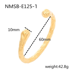 Detail view of gold textured stainless steel cuff with measurements and specifications