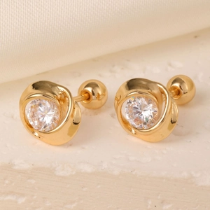 Macro shot of gold-plated vortex earrings with clear cubic zirconia and screw back