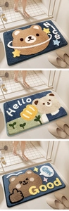 Detailed view of three cute cartoon bear bath mats with absorbent plush texture