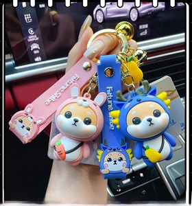 Detail of pink rabbit and blue dragon Fortune Shiba Inu charms with silicone wrist straps