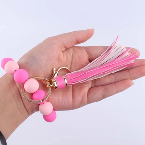 Pink silicone beaded wristlet keychain with wooden bead and leather tassel accessory
