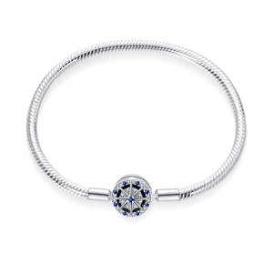 Detailed macro view of S925 silver snake chain bracelet with blue stone compass clasp