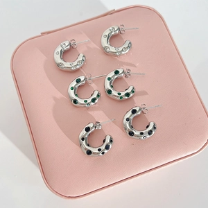 Three pairs of silver C-shaped titanium steel hoop earrings with crystal and gem inlays