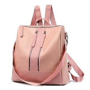 Pink minimalist leather backpack for women with vertical zippers and wide fabric strap
