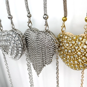 Detail shot of heart-shaped evening bags featuring silver and gold rhinestone inlay