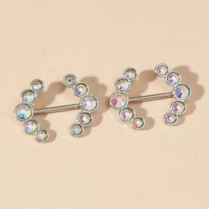 Detail of nipple rings with rainbow cubic zirconia and polished silver metal bars