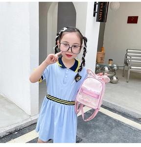 Pink kids sequin backpack with bunny ears and glitter pocket shown in outdoor setting