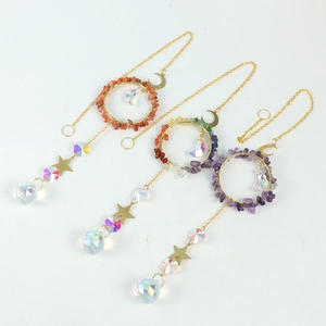 Three gold suncatchers with moon and star pendants, crushed stones, and crystal prisms