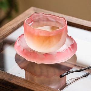 Macro detail of a pink gradient frosted glass teacup with unique lotus leaf edges
