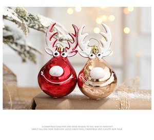 Close-up of red and champagne gold reindeer ornaments on festive rustic packaging
