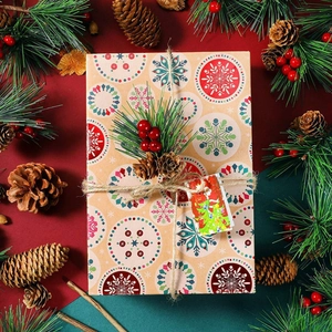 Christmas gift box with pine cones and berries on vintage kraft paper packaging