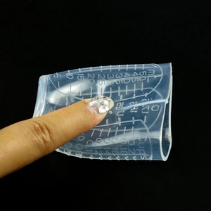 Close-up of flexible 50ml silicone measuring cup with clear dual scale for resin mixing