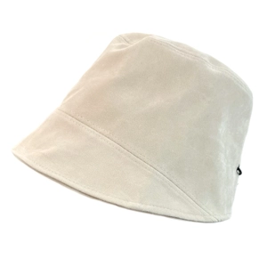 Detail view of the fine stitching and soft suede texture on a beige bucket hat