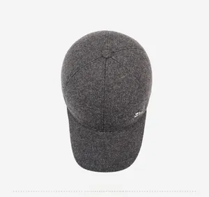 Top view of dark grey wool blend baseball cap with metallic logo and textured fabric