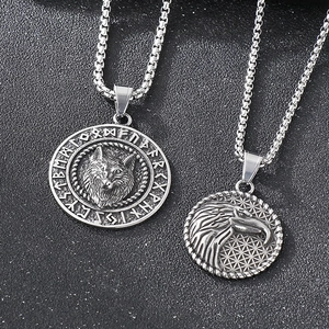 Close-up of Norse Viking wolf and eagle pendants with runes on square pearl chains