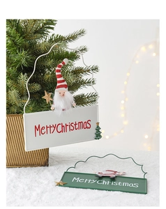 Detail of Christmas iron hanging signs with Merry Christmas text and festive characters