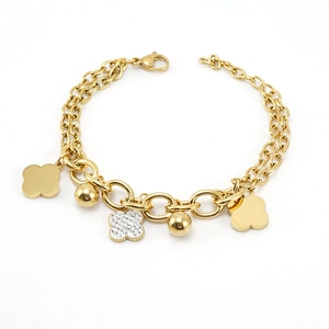 Detail view of 18k gold plated stainless steel bracelet with clover and bead charms