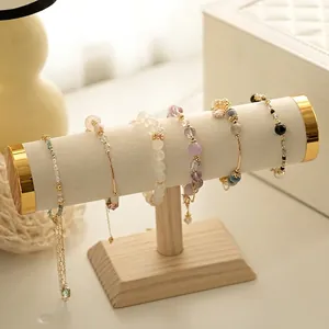 Single-bar wooden bracelet display stand with premium cream leather and gold metal ends