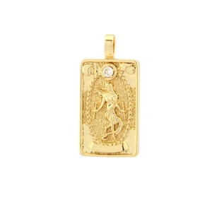 Close-up of gold tarot pendant featuring embossed female figure and white zircon inlay