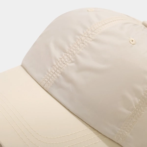 Close-up of high-density stitching and breathable texture on the beige outdoor sun hat