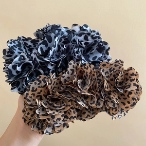 Detailed view of leopard print fabric flower hair clips with soft chiffon petals