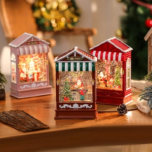 Festive Christmas candy house music boxes with glowing snow globes and Santa decorations