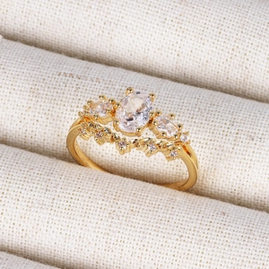 Macro shot of 18K gold crown ring featuring an oval zircon and fine crystal detailing