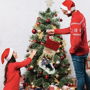 Hanging Christmas stocking with dachshund print and Merry Christmas text on tree