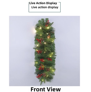 Detail of Christmas pine needle wreath with pinecones, red berries, and warm LED lights