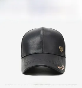 Detail of black leather baseball cap with fine texture and metallic shield emblem