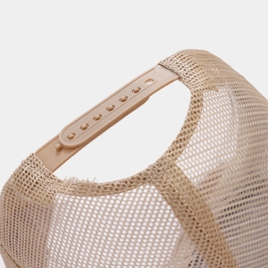 Detail view of breathable beige mesh and adjustable snapback closure on trucker hat