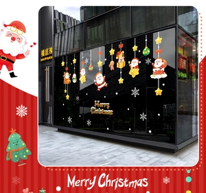 Detail view of festive Christmas window decals featuring Santa, reindeer and stars on glass