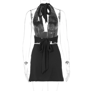 Detail of black two-piece set featuring backless halter top with a large bow tie design
