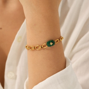Elegant gold-plated stainless steel chain bracelet with a green malachite pendant on model