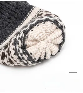 Close-up of the durable top stitching on a warm mixed grey and white knitted beanie cap