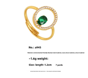 Macro detail of gold-plated titanium steel ring with green zircon and clear stones