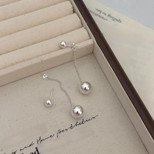Detailed view of long sterling silver tassel drop earrings with polished spherical beads