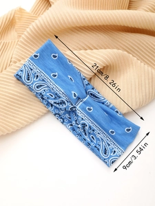 Detail view of blue paisley yoga headband with 21cm length and 9cm width measurements